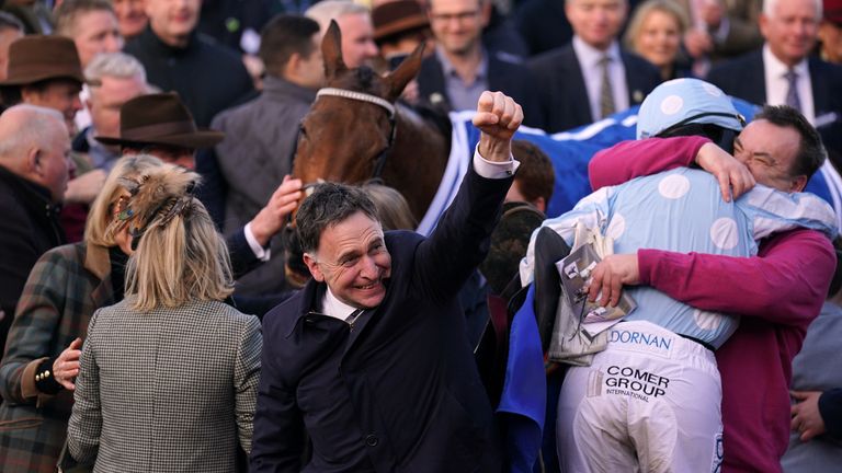 Henry de Bromhead punches the air as Rachael Blackmore gets a big hug from Honeysuckle's owner Kenny Alexander