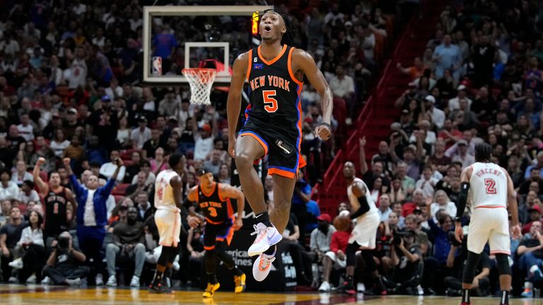 New York Knicks guard Immanuel Quickley leaps up to celebrate.