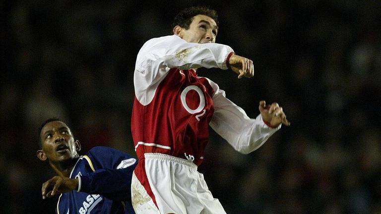Jefferson Louis challenges for a header with Martin Keown in Oxford's FA Cup tie with Arsenal