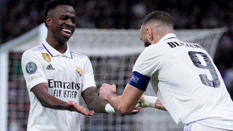 Real Madrid's Karim Benzema, right, celebrates with Real Madrid's Vinicius Junior after scoring his side's first goal during the Champions League round of 16 second leg match between Real Madrid and Liverpool at the Santiago Bernabeu Stadium.  In Madrid, Spain, Wednesday, March 15, 2023.  (AP Photo/Bernat Armangue)