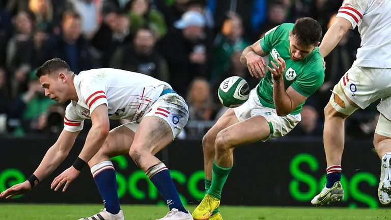 18 March 2023; Hugo Keenan of Ireland goes down after a tackle by Freddie Steward of England, 