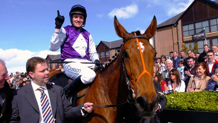 Kicking King and jockey Barry Geraghty is led into the winners enclosure by owner Conor Clarkson after winning the Punchestown Guinness Gold Cup.