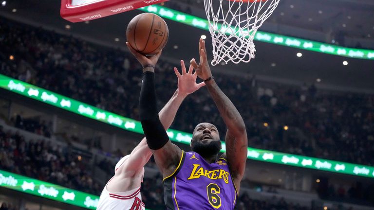 Los Angeles Lakers' LeBron James drives to the basket as Chicago Bulls' Alex Caruso defends.