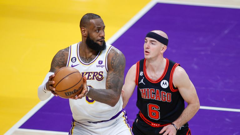Los Angeles Lakers forward LeBron James (6) is defended by Chicago Bulls guard Alex Caruso (6) during an NBA basketball game at Crypto.com Arena, Sunday, March 26, 2023, in Los Angeles. (Ringo Chiu via AP)