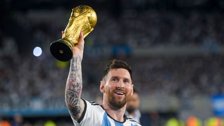 Argentina's Lionel Messi hoists the winning team's replica FIFA World Cup trophy during a celebration ceremony for local fans after an international friendly soccer match against Panama at the Monumental Stadium in Buenos Aires , in Argentina, Thursday, March 23, 2023. (AP Photo/Gustavo Garello)