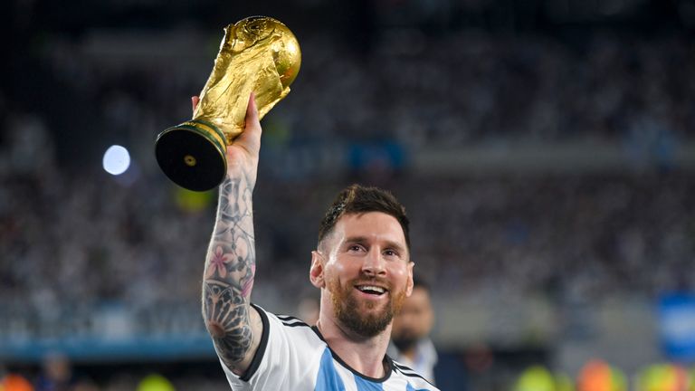 Argentina's Lionel Messi hoists the winning team replica of the FIFA World Cup trophy during a celebration ceremony for local fans after an international friendly soccer match against Panama at the Monumental stadium in Buenos Aires, Argentina, Thursday, March 23, 2023. (AP Photo/Gustavo Garello)