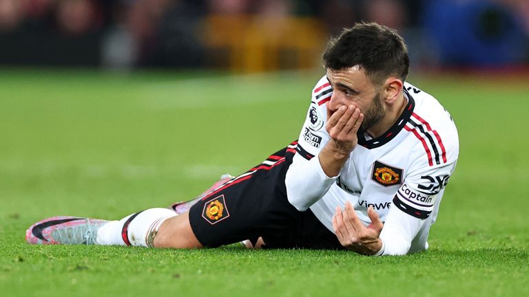Manchester United's Bruno Fernandes on the ground with his hand on his mouth