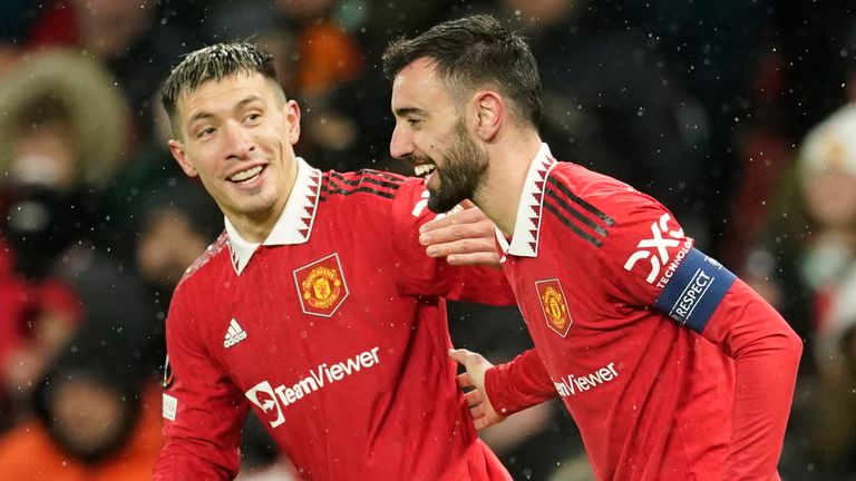 Manchester United's Bruno Fernandes, right, celebrates after scoring his side's third goal during the Europa League round of 16 first leg soccer match between Manchester United and Real Betis at the Old Trafford stadium in Manchester, Thursday, March 9, 2023. (AP Photo/Dave Thompson)