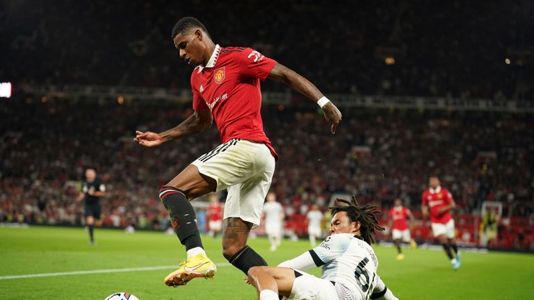 Manchester United&#39;s Marcus Rashford, left, challenges for the ball with Liverpool&#39;s Trent Alexander-Arnold during the English Premier League soccer match between Manchester United and Liverpool at Old Trafford stadium, in Manchester, England, Monday, Aug 22, 2022. (AP Photo/Dave Thompson)