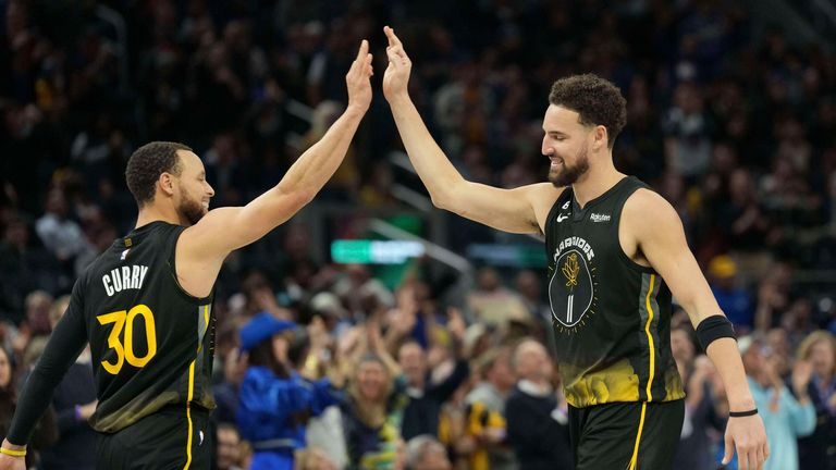 Golden State Warriors guards Stephen Curry (30) and Klay Thompson (11) celebrate.