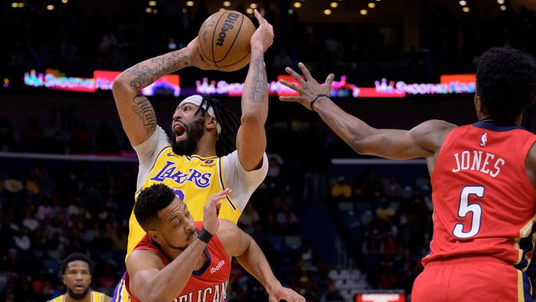 Los Angeles Lakers forward Anthony Davis (3) shoots against New Orleans Pelicans guard CJ McCollum (3) in the first half of an NBA basketball game in New Orleans, Tuesday, March 14, 2023.