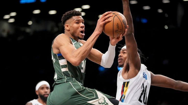 Milwaukee Bucks forward Giannis Antetokounmpo (34) looks to pass on a drive against Brooklyn Nets center Day'Ron Sharpe.