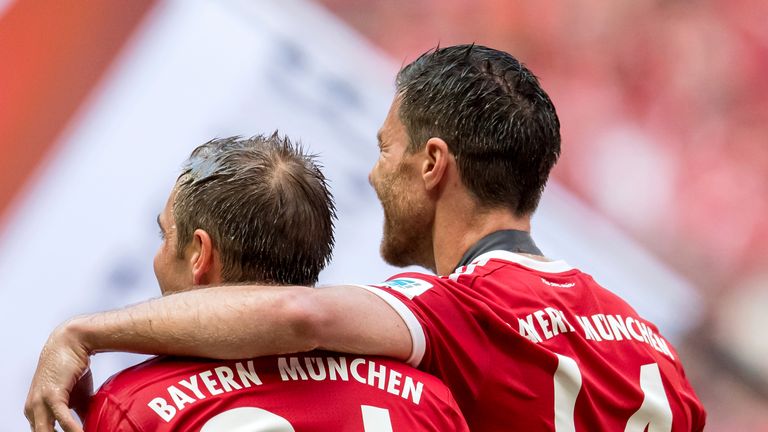 Bayern Munich&#39;s Philipp Lahm and Xabi Alonso leave the field at the end of the German Bundesliga soccer match between Bayern Munich and SC Freiburg in thr Allianz Arena in Munich, Germany, 20 May 2017. 