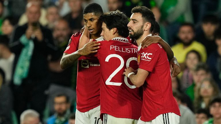 Manchester United's Marcus Rashford, left, celebrates after scoring his side's first goal during the Europa League round of 16 second leg soccer match between Real Betis and Manchester United at the Benito Villamarin stadium in Seville, Spain, Thursday, March 16, 2023. (AP Photo/Jose Breton)