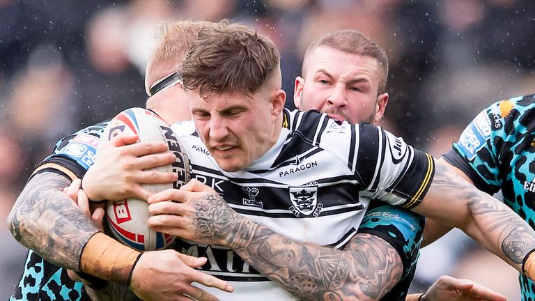 Picture by Allan McKenzie/SWpix.com - 25/03/2023 - Rugby League - Betfred Super League Round 6 - Hull FC v Leigh Leopards - MKM Stadium, Kingston upon Hull, England - Hull FC's Liam Sutcliffe is tackled by Leigh's Oliver Holmes & Zak Hardaker.