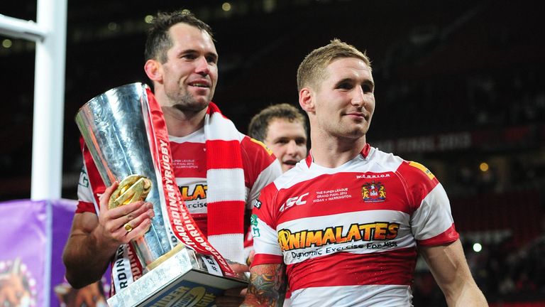 Wigan Warriors' Pat Richards and Sam Tomkins celebrate with the trophy after winning the Super League Grand Final at Old Trafford, Manchester. PRESS ASSOCIATION Photo. Picture date: Saturday October 5, 2013. Photo credit should read: Anna Gowthorpe/PA Wire. RESTRICTIONS: Editorial use only, no commercial use (including paid for mobile use) without prior permission.