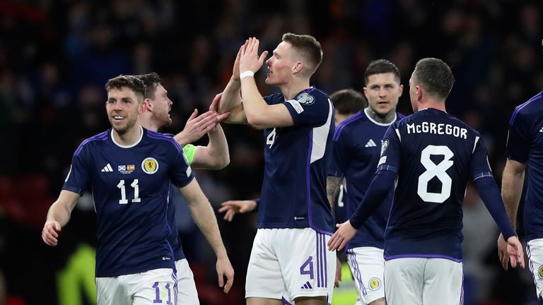 Scotland's Scott McTominay, third from left, celebrates with his teammates after scoring his side's second goal during the Euro 2024 group A qualifying soccer match between Scotland and Spain at the Hampden Park stadium in Glasgow, Scotland, Tuesday, March 28, 2023. (AP Photo/Scott Heppell)
