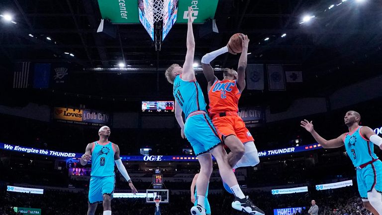 Oklahoma City Thunder guard Shai Gilgeous-Alexander (2) shoots as Phoenix Suns center Jock Landale (11) defends.