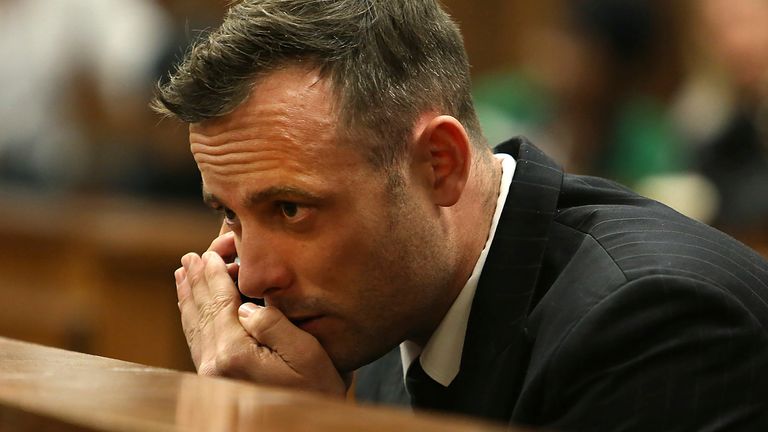 FILE - Oscar Pistorius speaks on a mobile phone in the High Court in Pretoria, South Africa, June 15, 2016 during his sentencing hearing for murdering girlfriend Reeva Steenkamp. Pistorius has applied for parole and is expected to attend a hearing on Friday, March 31, 2023 that will decide if the former Olympic runner is released from prison 10 years after killing girlfriend Reeva Steenkamp. (Alon Skuy/Pool Photo via AP, File)