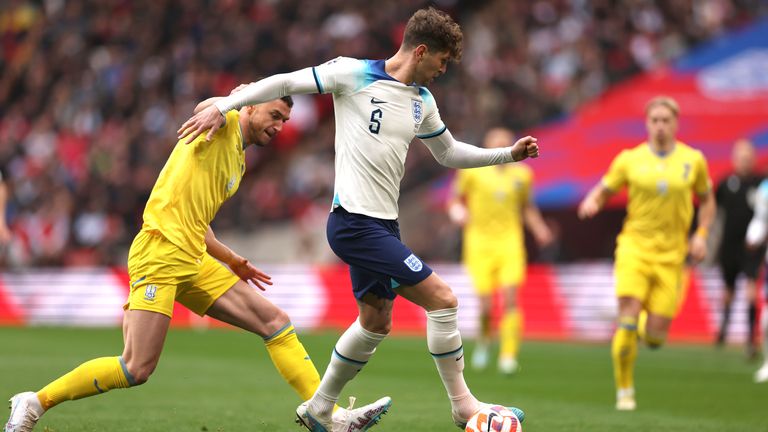 Ukraine&#39;s Roman Yaremchuk, left, and England&#39;s John Stones vie for the ball during the Euro 2024 group C qualifying soccer match between England and Ukraine at Wembley Stadium in London, Sunday, March 26, 2023.(AP Photo/Ian Walton)