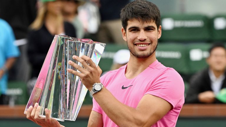 Carlos Alcaraz holds the championship trophy after winning the finals of the BNP Paribas Open tennis in Indian Wells