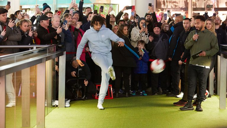 Alexander-Arnold takes a free kick as Liverpool fans watch as he opens a new store in Liverpool. 