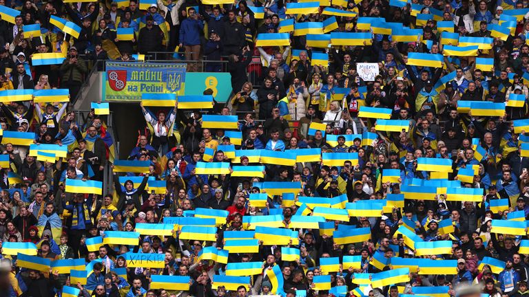 Fans show Ukrainian flags before the game