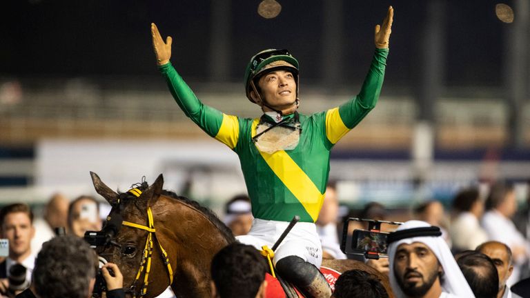Ushba Tesoro's jockey Yuga Kawada celebrates as the Dubai World Cup winner is led back in