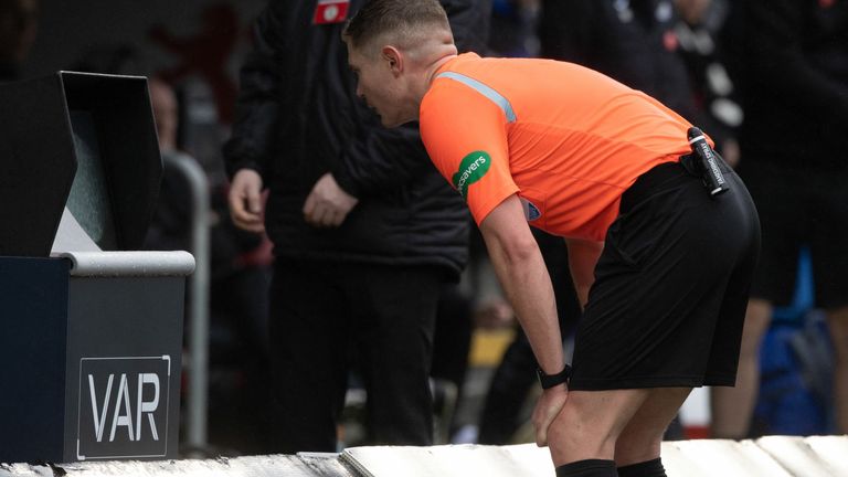 Referee David Dickinson checks the monitor and awards Celtic a penalty during a cinch Premiership match between St Mirren and Celtic at the SMiSA Stadium