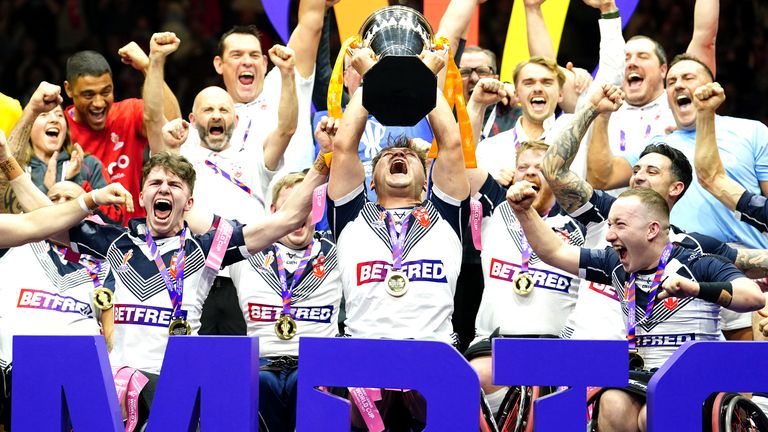 England&#39;s Tom Halliwell lifts the trophy with team-mates after victory in the Wheelchair Rugby League World Cup final match at Manchester Central 