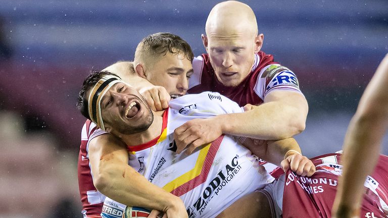 Picture by Allan McKenzie/SWpix.com - 09/03/2023 - Rugby League - Betfred Super League Round 4 - Wigan Warriors v Catalans Dragons - DW Stadium, Wigan, England - Catalans' Benjamin Garcia is tackled by Wigan's LIam Farrell & Sam Powell.