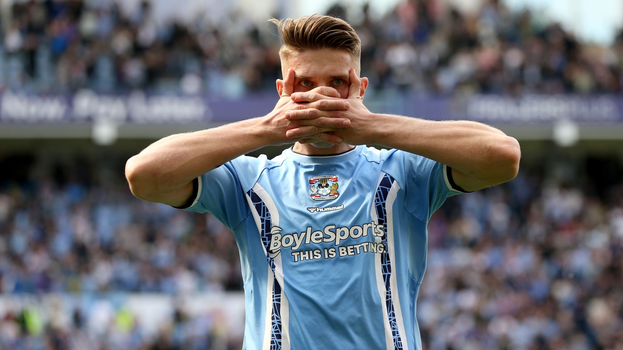  Viktor Gyokeres, a Swedish professional footballer who plays as a striker for EFL Championship club Coventry City, is pictured celebrating a goal with his hands covering his face.