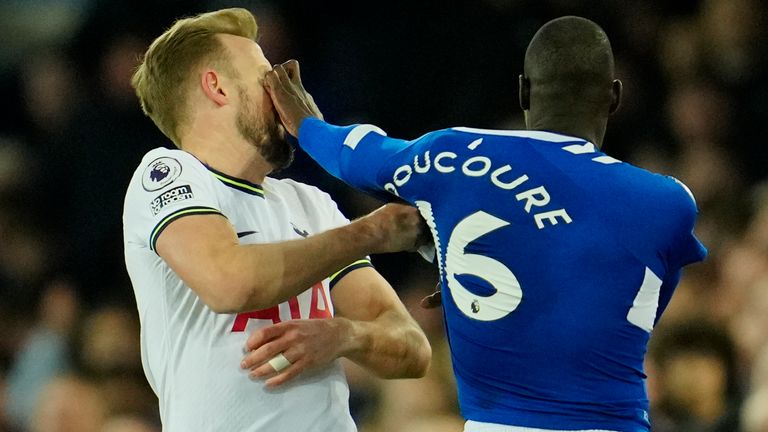 Tottenham's Harry Kane is pushed by Everton's Abdoulaye Doucoure during the English Premier League soccer match between Everton and Tottenham Hotspur at the Goodison Park stadium in Liverpool, England, Monday, April 3, 2023. (AP Photo/Jon Super)