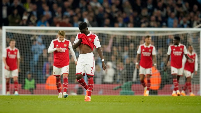 Arsenal's Bukayo Saka, center, reacts after Manchester City's scored their third goal during the English Premier League soccer match between Manchester City and Arsenal at Etihad stadium in Manchester, England, Wednesday, April 26, 2023. (AP Photo/Dave Thompson)