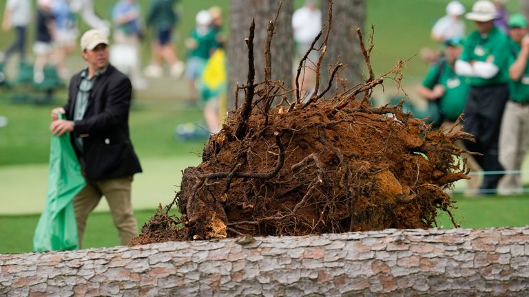 Authorities investigate the scene where trees fell on the 17th hole during the second round of the Masters golf tournament at Augusta National Golf Club on Friday, April 7, 2023, in Augusta, Ga. (AP Photo/Mark Baker)