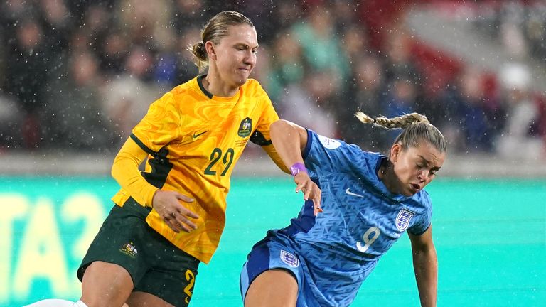 Australia&#39;s Clare Hunt and England&#39;s Alessia Russo battle for the ball