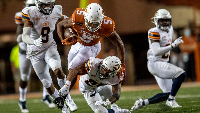 Texas Longhorns running back Bijan Robinson (5) fights for yardage as UTEP Miners defensive back Broderick Harrell (28) tries to bring him down during an NCAA football game in Austin, Texas Saturday, Sept. 12, 2020  [RICARDO B. BRAZZIELL/AMERICAN-STATESMAN]