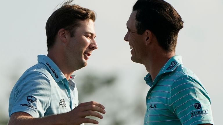 Billy Horschel, right, greets Sam Burns after they finish the first round of the PGA Zurich Classic golf tournament at TPC Louisiana in Avondale, La., Thursday, April 21, 2022. (AP Photo/Gerald Herbert)