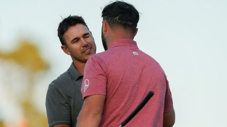 Brooks Koepka, left, congratulates Jon Rahm, of Spain, on Rahm's winning the Masters golf tournament at Augusta National Golf Club on Sunday, April 9, 2023, in Augusta, Ga. (AP Photo/Charlie Riedel)