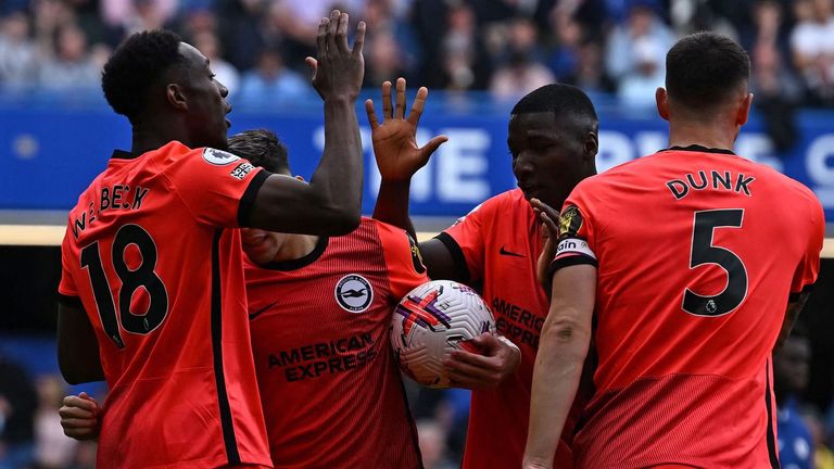 Danny Welbeck high-fives his team-mates after equalising for Brighton at Stamford Bridge