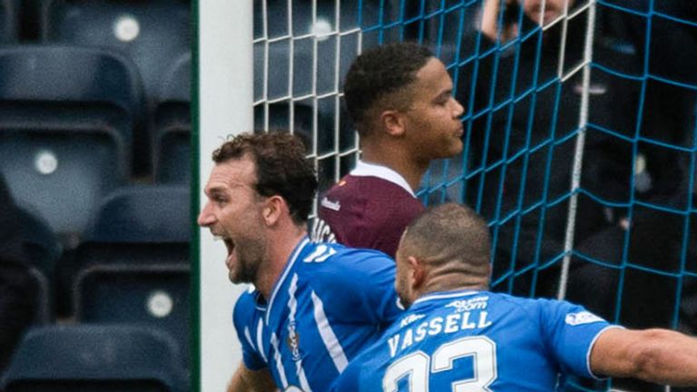 KILMARNOCK, SCOTLAND - APRIL 01: Kilmarnock's Christian Doidge runs to celebrate after scoring to make it 2-1 whilst Hearts Zander Clark goes down again with an injury during a cinch Premiership match between Kilmarnock and Heart of Midlothian at Rugby Park, on April 01, 2023, in Kilmarnock, Scotland.  (Photo by Mark Scates / SNS Group)