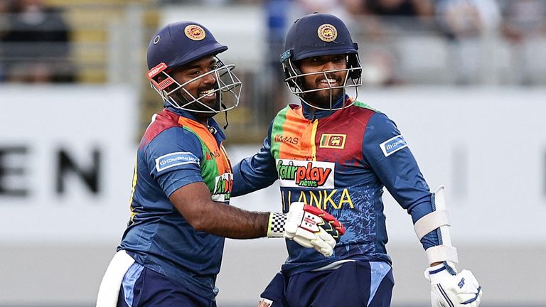 Sri Lanka's Charith Asalanka (L) and Kusal Mendis celebrate winning the super over and the match during the first Twenty 20 international cricket match between New Zealand and Sri Lanka at Eden Park in Auckland on April 2, 2023. (Photo by DAVID ROWLAND / AFP) (Photo by DAVID ROWLAND/AFP via Getty Images)
