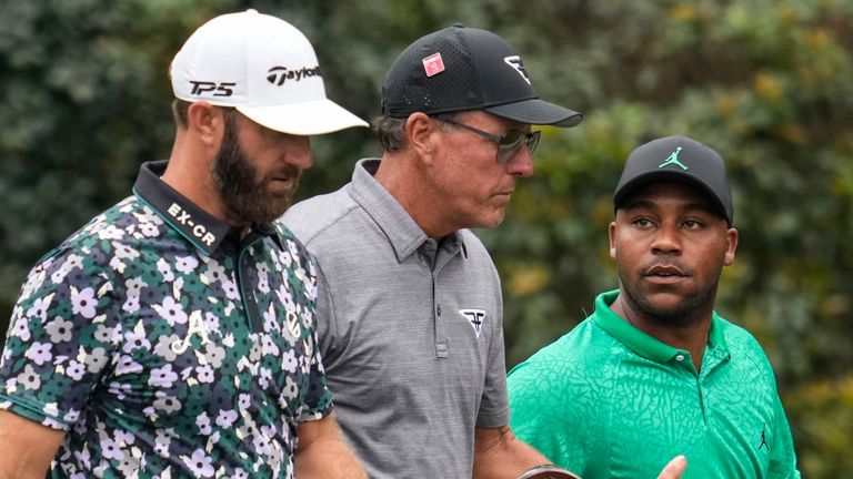 Dustin Johnson, Phil Mickelson, and Harold Varner III, walks in the 11th fairway during a practice for the Masters golf tournament at Augusta National Golf Club, Tuesday, April 4, 2023, in Augusta, Ga. (AP Photo/Mark Baker)