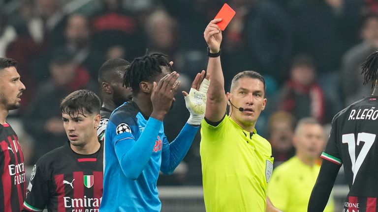 Referee Istvan Kovacs from Romania, center, shows a red card to Napoli's Andre-Frank Zambo Anguissa, center, left, during the Champions League quarterfinal, first leg, soccer ma