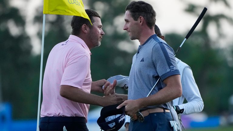 Sean O'Hair, left, greets teammate Brandon Matthews after finishing the day on the 18th green during the first round of the PGA Zurich Classic golf tournament at TPC Louisiana in Avondale, La., Thursday, April 20, 2023. (AP Photo/Gerald Herbert)