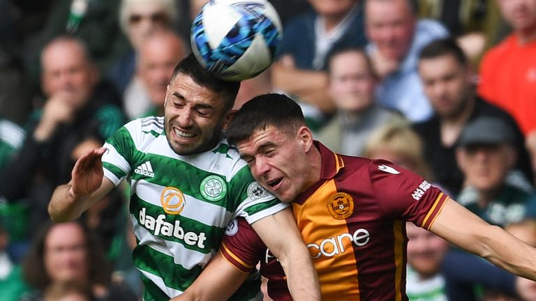 Celtic's Greg Taylor (L) and Motherwell's Max Johnston in action