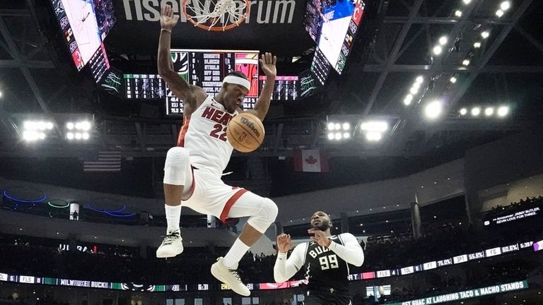 Miami Heat&#39;s Jimmy Butler dunks over Milwaukee Bucks&#39; Jae Crowder during the first half in Game 1 of an NBA basketball first-round playoff series Sunday, April 16, 2023, in Milwaukee. The Heat won 130-117 to take a 1-0 lead in the series. (AP Photo/Morry Gash)