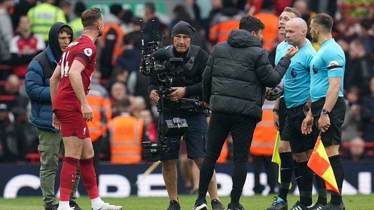 Jordan Henderson speaks to assistant referee Scott Ledger after claims Andrew Robertson was elbowed by match official Constantine Hatzidakis