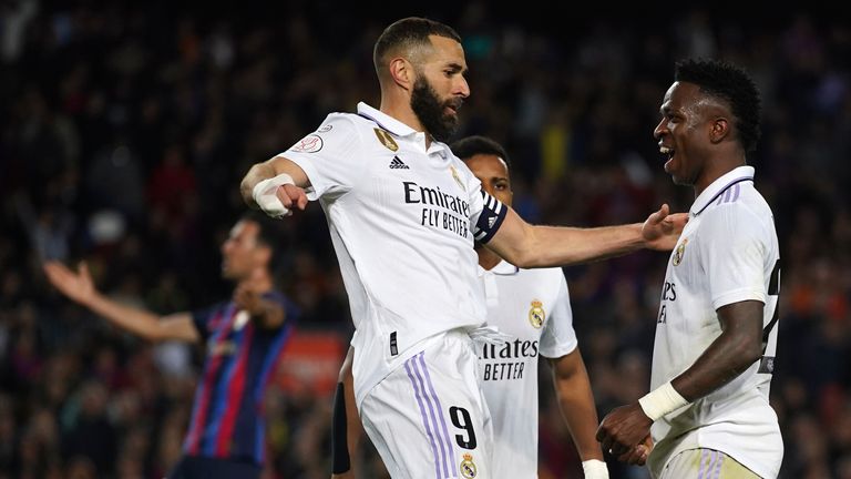 Real Madrid's Vinicius Junior, right, celebrates with Real Madrid's Karim Benzema after scoring his sides first goal during the Spanish Copa del Rey semifinal, second leg soccer match between Barcelona and Real Madrid at the Camp Nou stadium in Barcelona, Spain, Wednesday, April 5, 2023. (AP Photo/Joan Mateu Parra)
