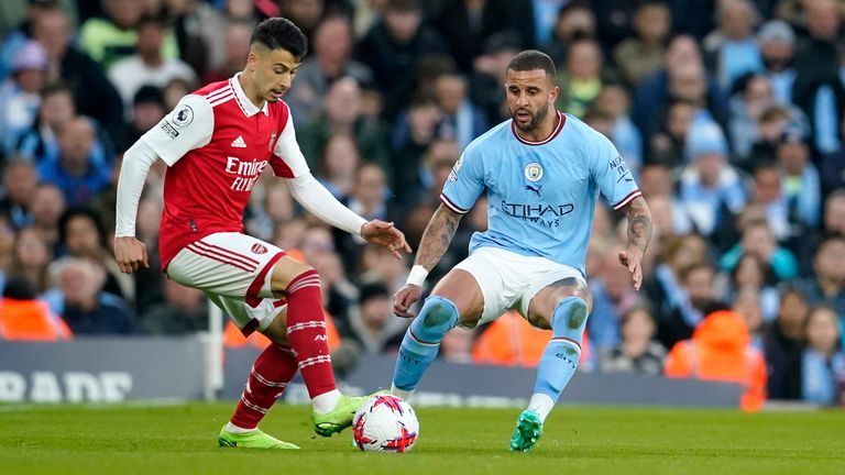 Manchester City's Kyle Walker, right, watches as Arsenal's Gabriel Martinelli controls the ball during the English Premier League soccer match between Manchester City and Arsenal at Etihad stadium in Manchester, England, Wednesday, April 26, 2023. (AP Photo/Dave Thompson)
